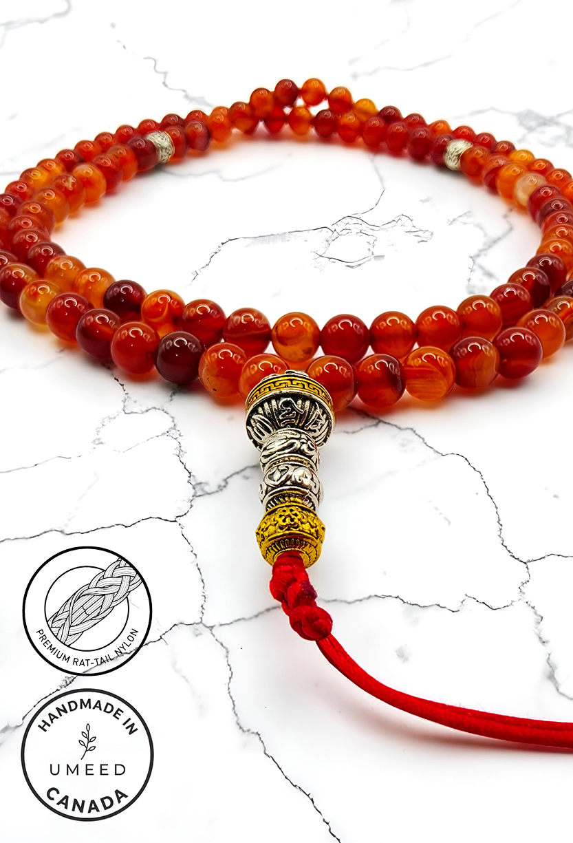 Handmade red and gold beaded mala necklace with decorative silver accents.