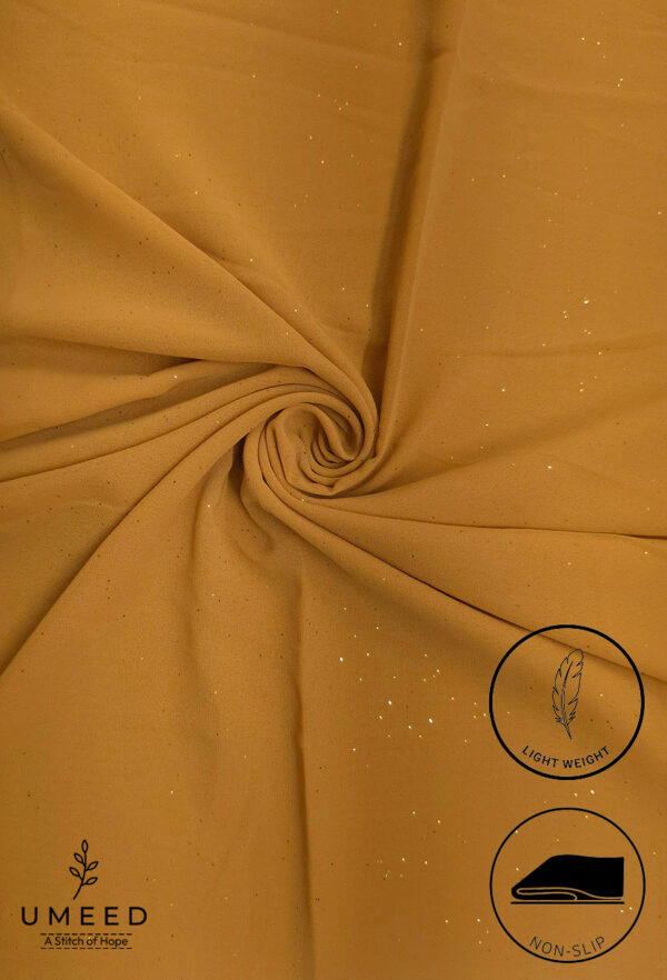 Golden fabric with subtle glitter and light weight label from Umeed Designs.