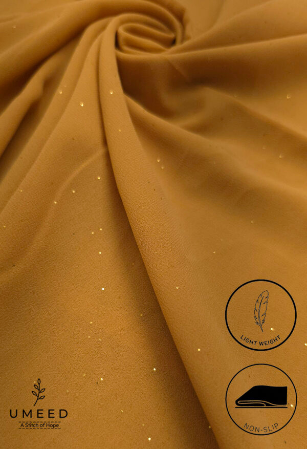 Gold fabric with glitter and light weight texture for fashion or decor.