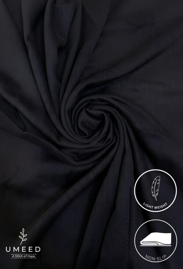 Black lightweight non-slip fabric with a swirling pattern for upholstery or clothing.