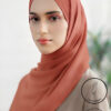 Elegant woman wearing a light weight, non-slip peach-colored hijab from Umeed Designs.