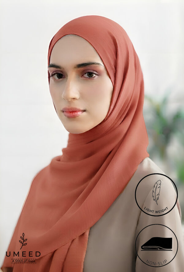 Elegant woman wearing a light weight, non-slip peach-colored hijab from Umeed Designs.