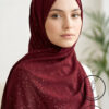 Beautiful woman wearing maroon hijab with gold accents for modest fashion.