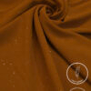 Lightweight, non-slip mustard-colored fabric with subtle glitter accents.
