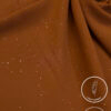 Brown lightweight fabric with gold specks for fashion or craft projects.
