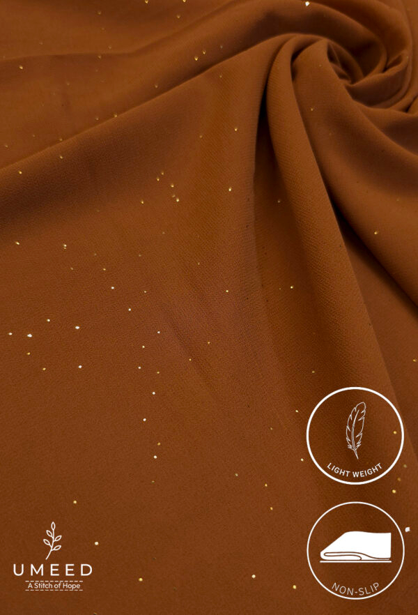 Brown lightweight fabric with gold specks for fashion or craft projects.