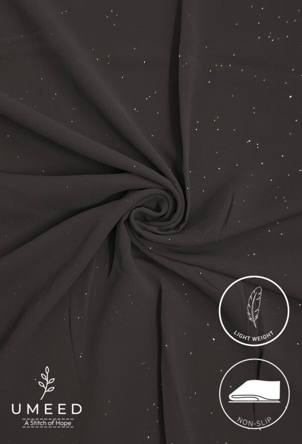 Lightweight black fabric with subtle gold specks for elegant fashion design.