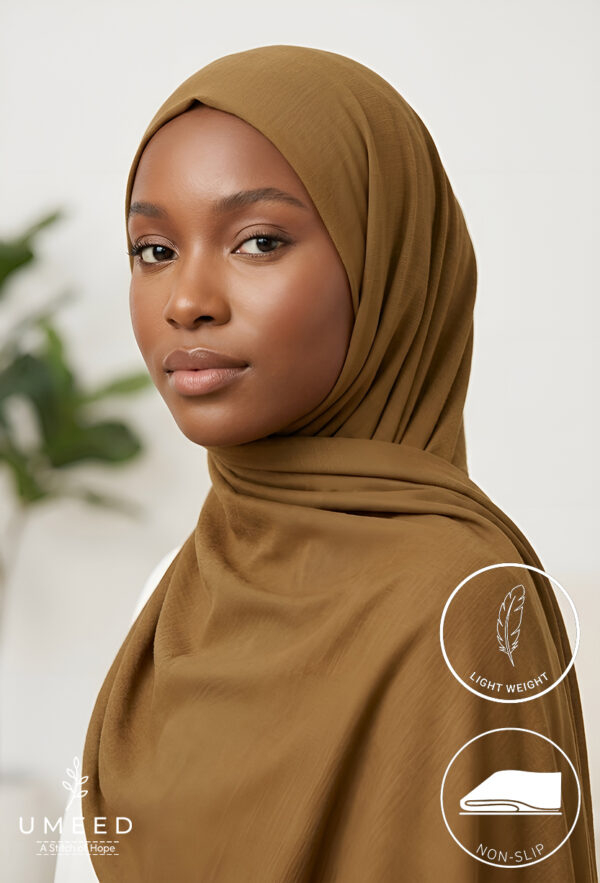 Elegant woman wearing a light weight, non-slip brown hijab for modest fashion.
