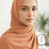 Elegant woman wearing a light weight, non-slip peach-colored hijab.