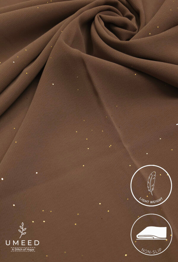 Lightweight, non-slip brown fabric with gold specks for elegant fashion design.
