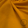 Mustard yellow fabric with subtle glitter and light weight for fashion design.