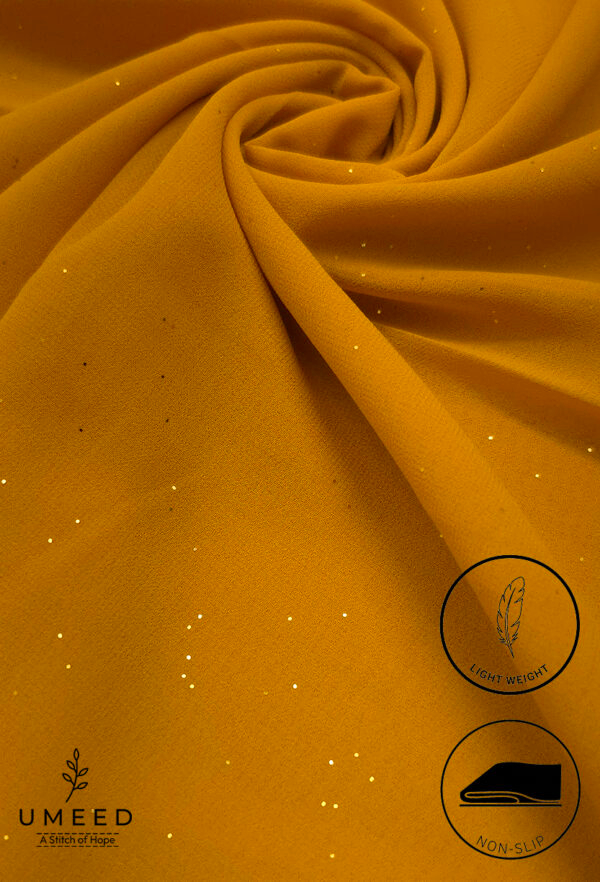 Mustard yellow fabric with subtle glitter and light weight for fashion design.