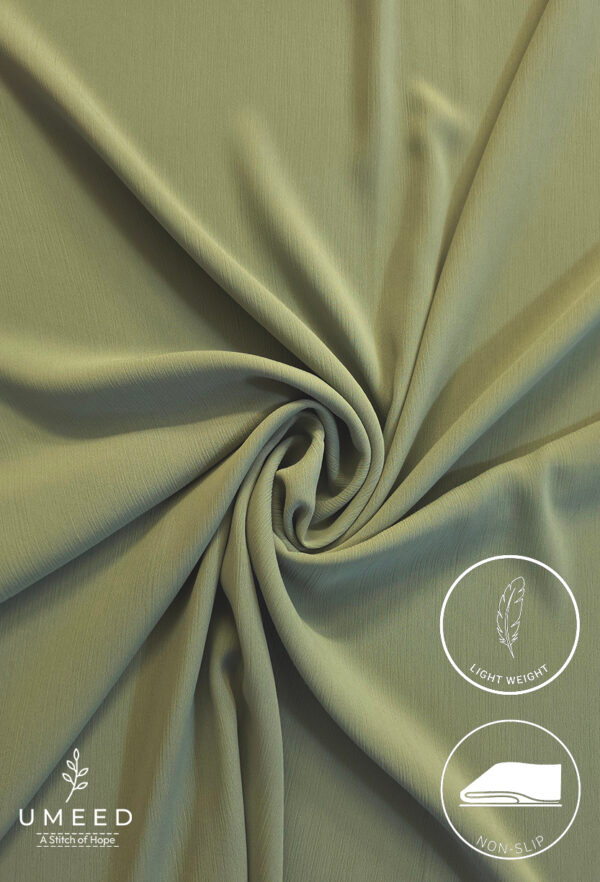 Lightweight, non-slip fabric in soft green for comfortable clothing or accessories.
