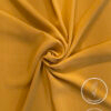 Lightweight, non-slip mustard yellow fabric for clothing or crafts.
