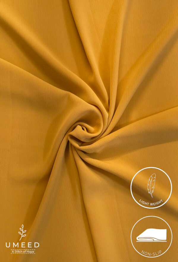 Lightweight, non-slip mustard yellow fabric for clothing or crafts.