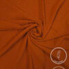 Lightweight, non-slip orange fabric with subtle glitter accents for fashion or decor.
