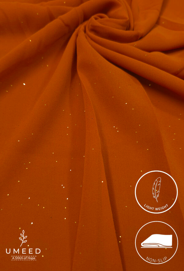 Orange lightweight, non-slip fabric with subtle glitter for elegant fashion designs.