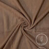 Lightweight, non-slip fabric in beige for clothing or crafts.
