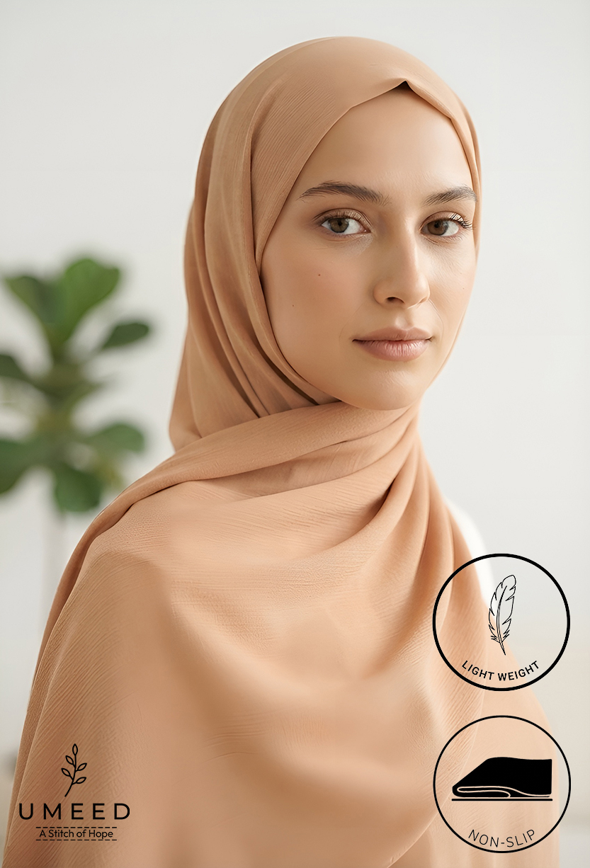 Elegant woman wearing a light beige hijab with a soft, smooth texture.