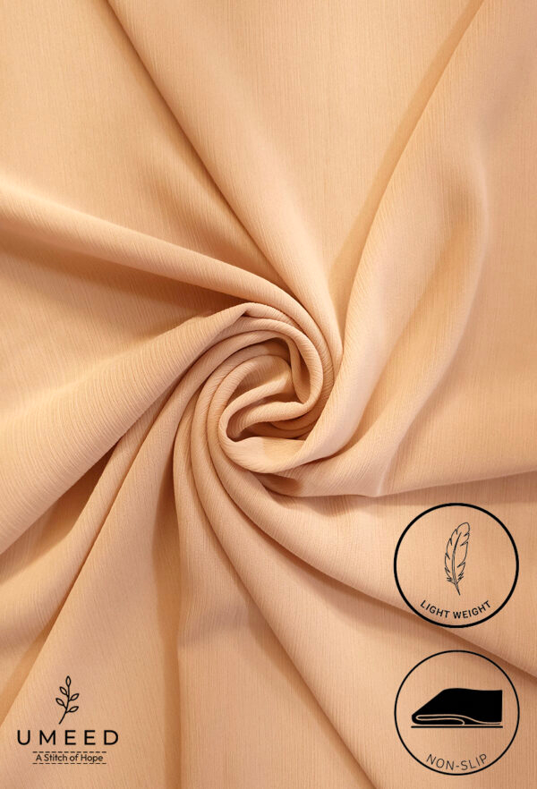 Light beige fabric with a smooth, flowing texture and gentle folds.