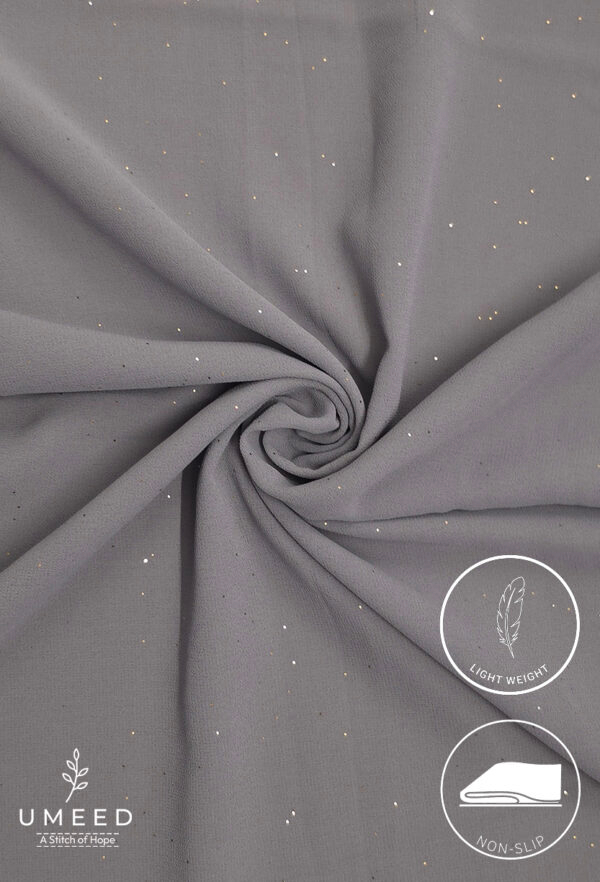 Lightweight grey fabric with subtle gold specks, ideal for elegant clothing.