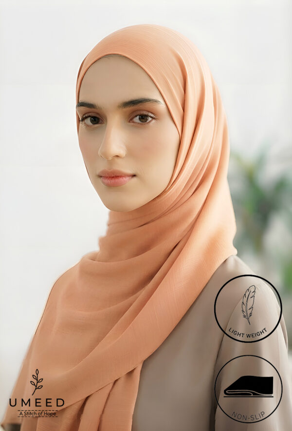 Elegant peach-colored hijab from Umeed Designs for modest fashion.