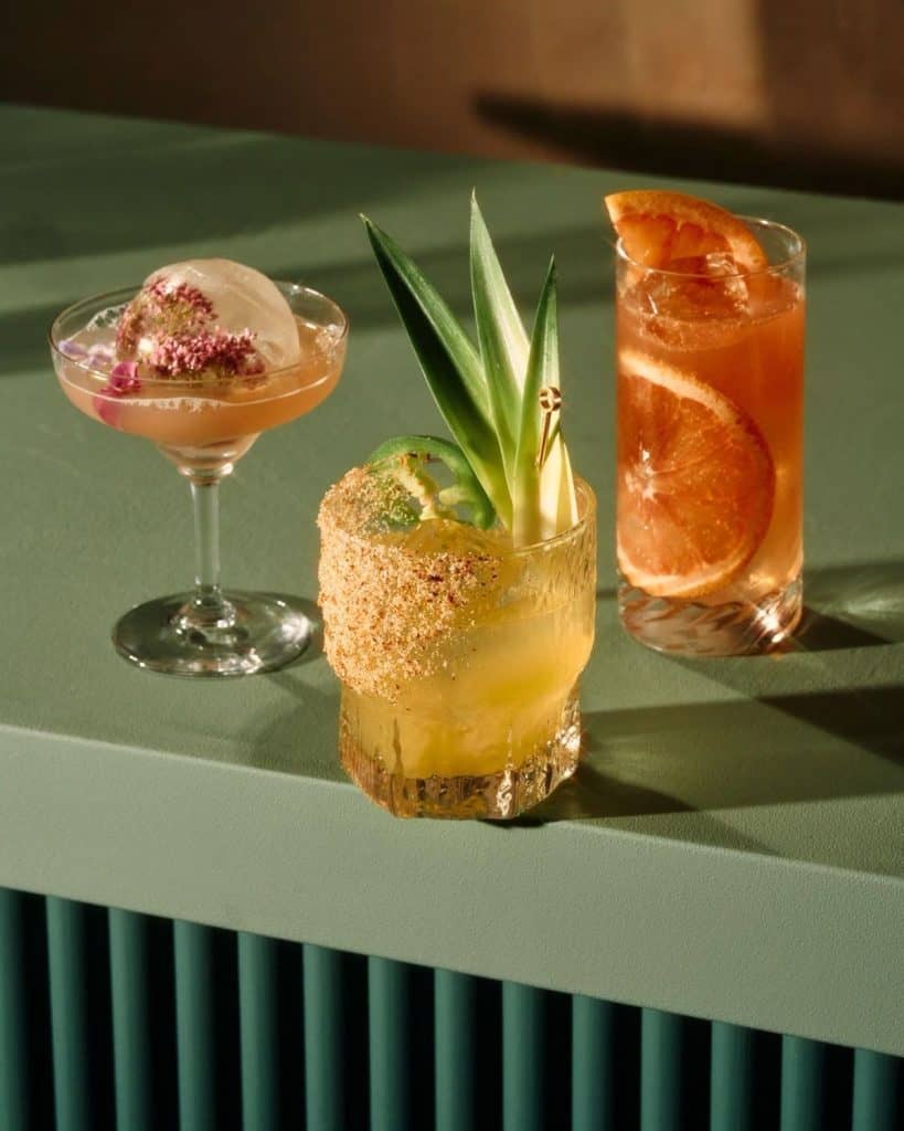 Assorted creative cocktails with tropical garnishes and decorative presentation.