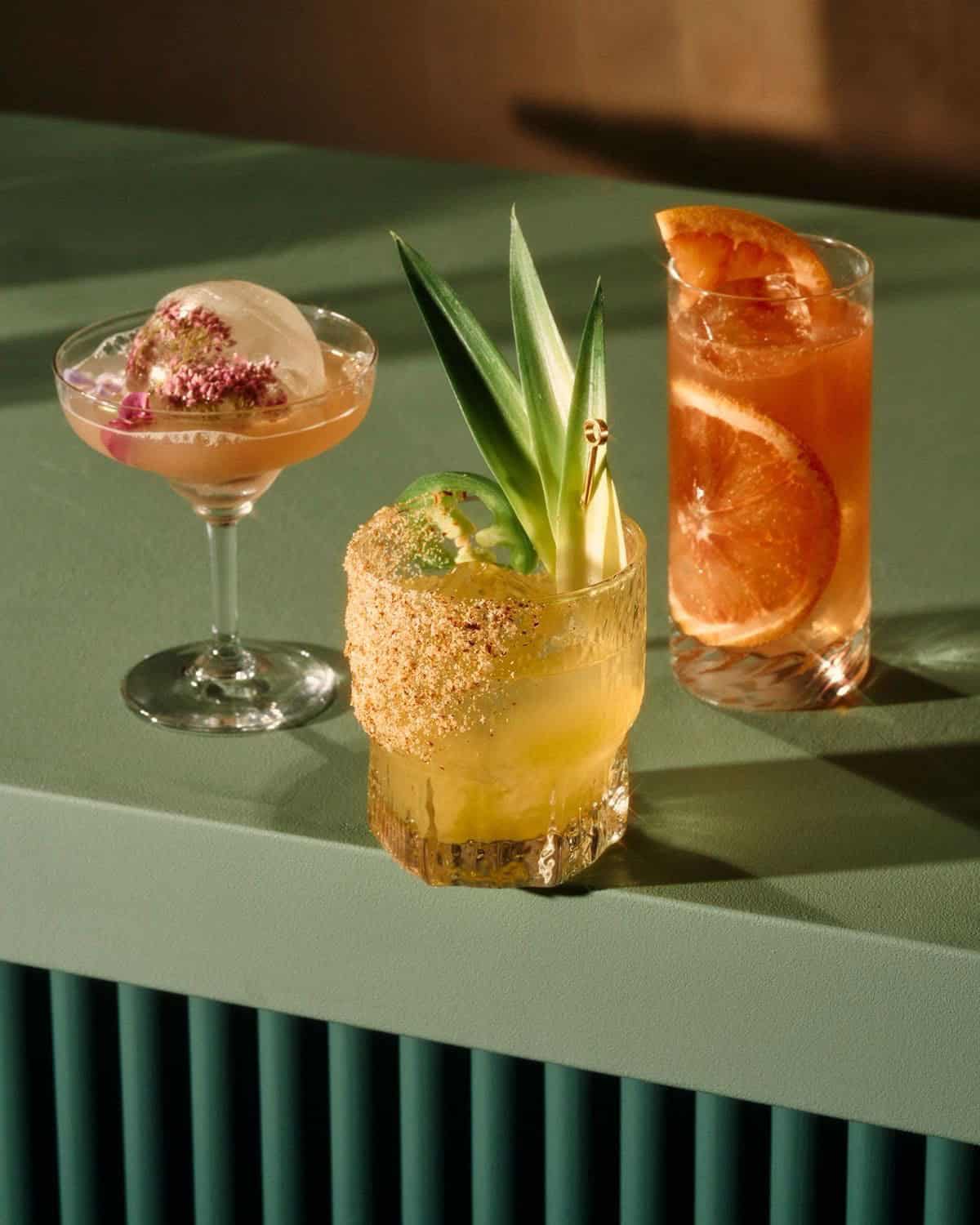 Assorted creative cocktails with tropical garnishes and decorative presentation.