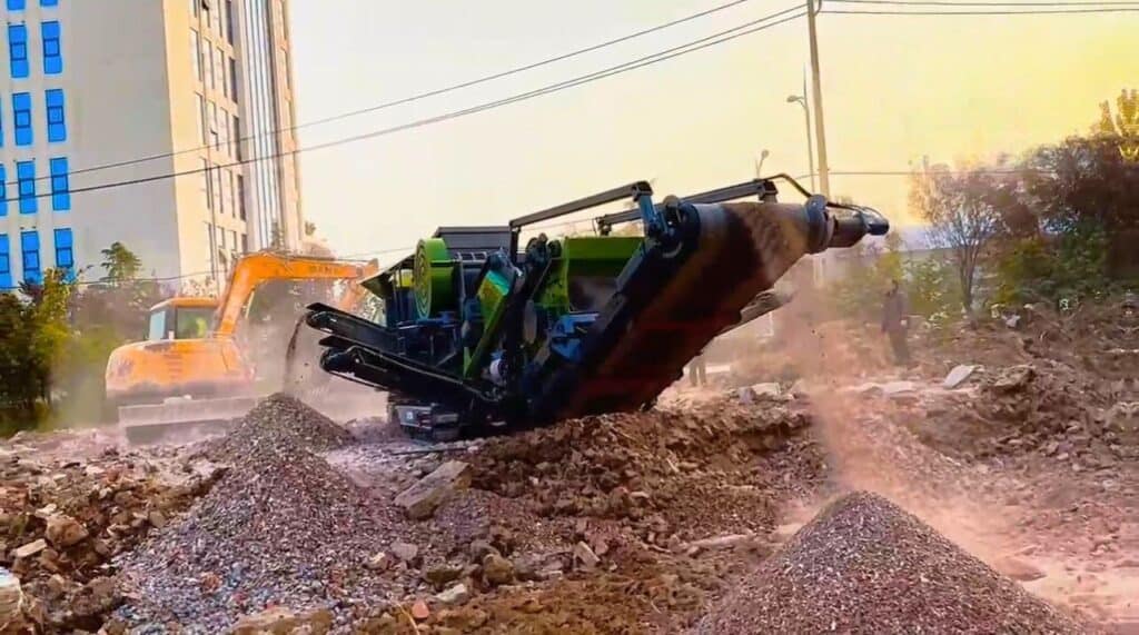 UPSEN dual jaw crusher with integrated screening equipment working beside aggregate stockpiles.