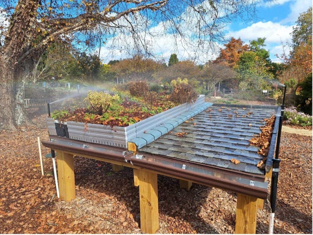 Tabletop green roof display with sedum plants and rain simulator at the UGA GSI demo site