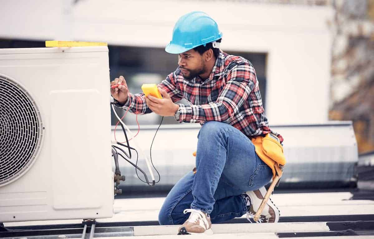Contractor working on an air conditioning unit