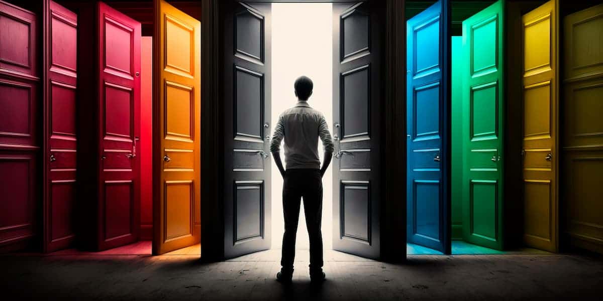 A man standing in front of many different colored doorways