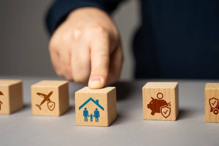 5 wooden blocks each with a different symbol on them representing a type of insurance