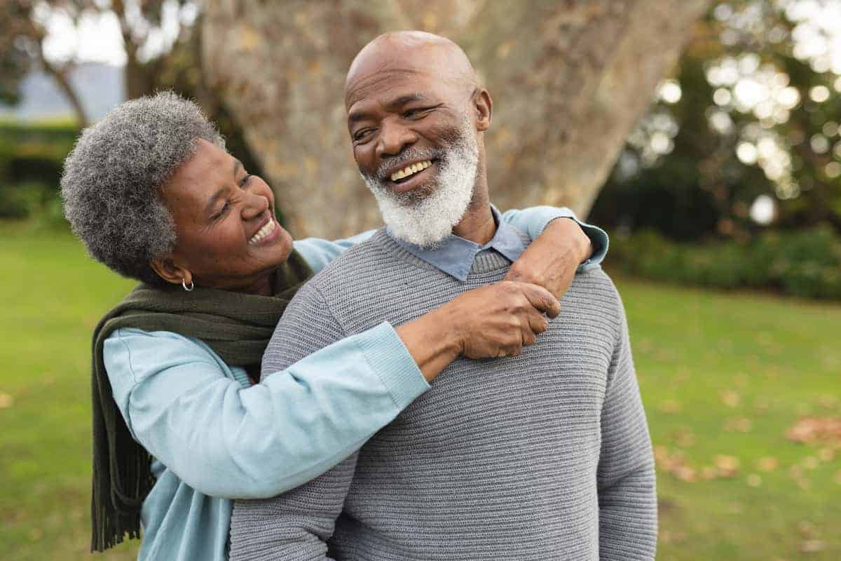 Elderly Couple hugging in a park