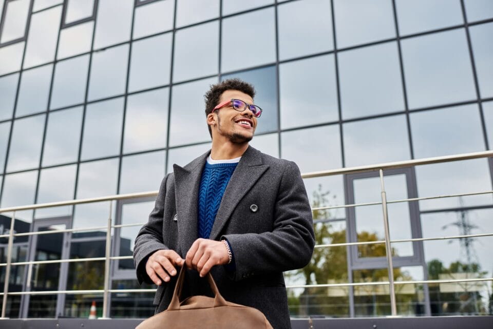 Life insurance agent standing confidently before a modern office building, conveying professionalism and strong branding.