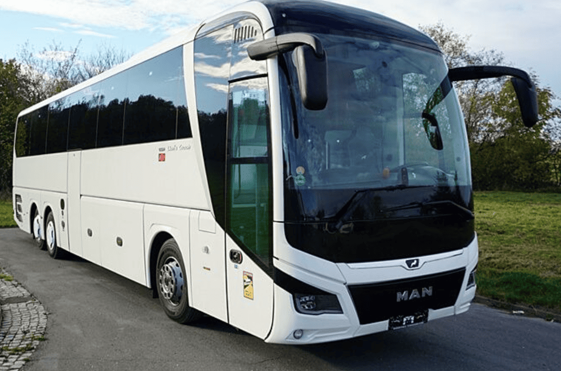 White full-size coach bus, front three-quarter view