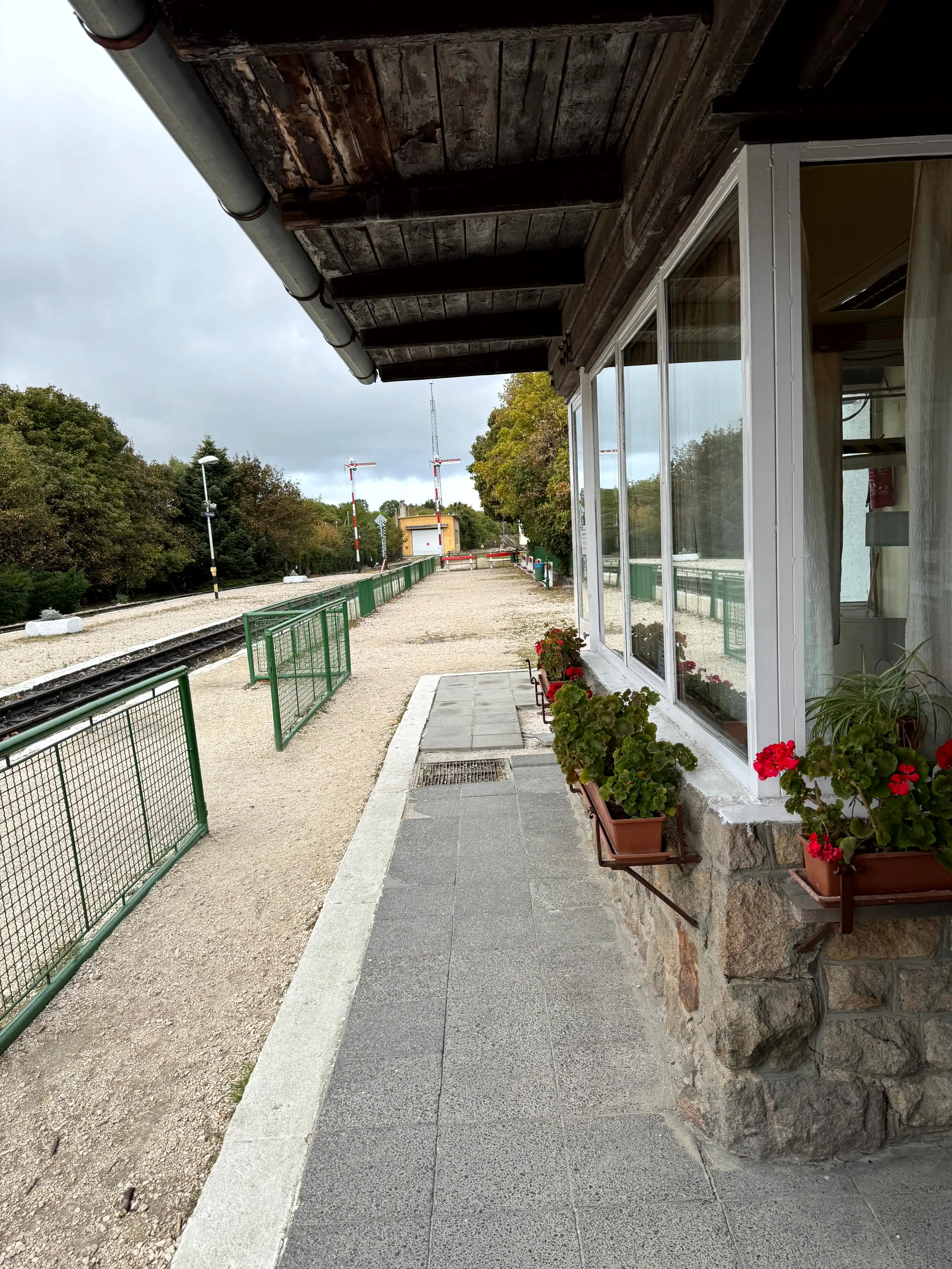 View of the station platform with flower pots outside a building in Budapest.