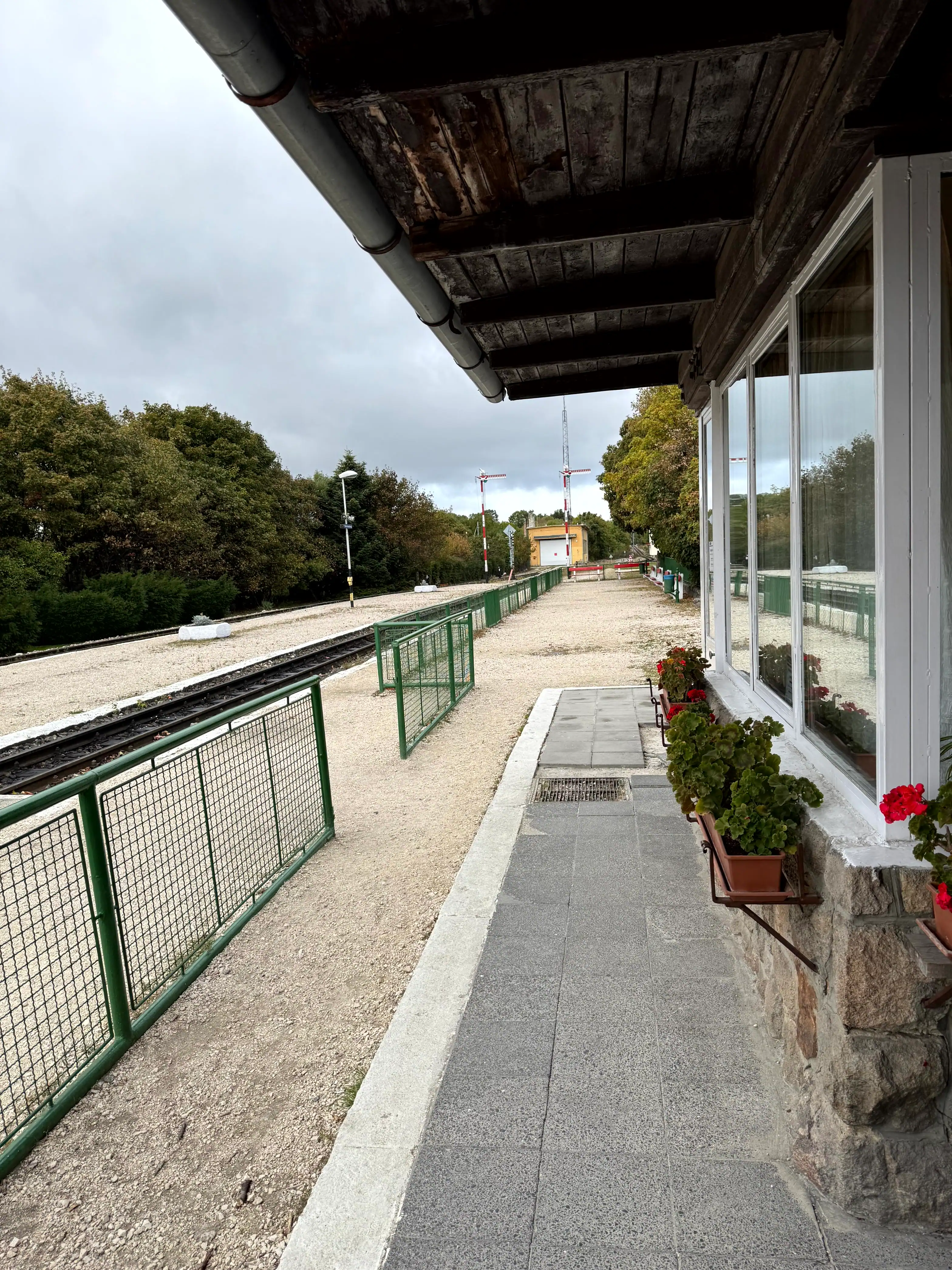 Airport transfer station with view of train platform and greenery.