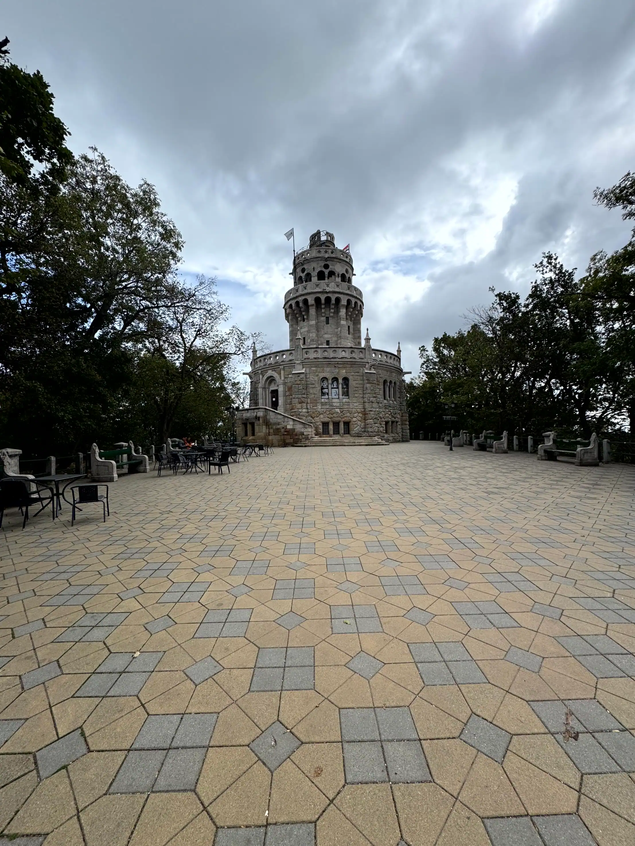 Buda Castle Tower in Budapest under cloudy sky.