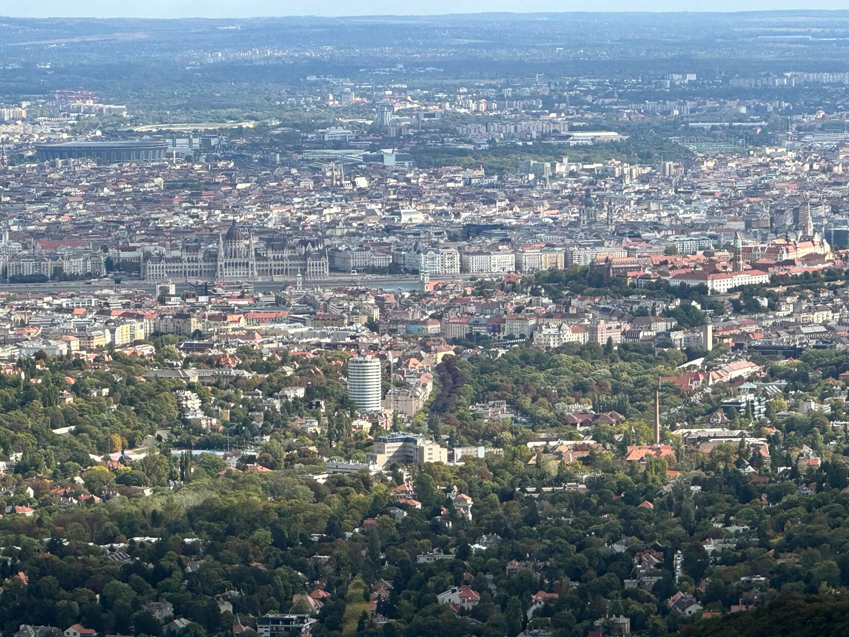 Aerial view of Budapest showcasing urban landscape and green parks.