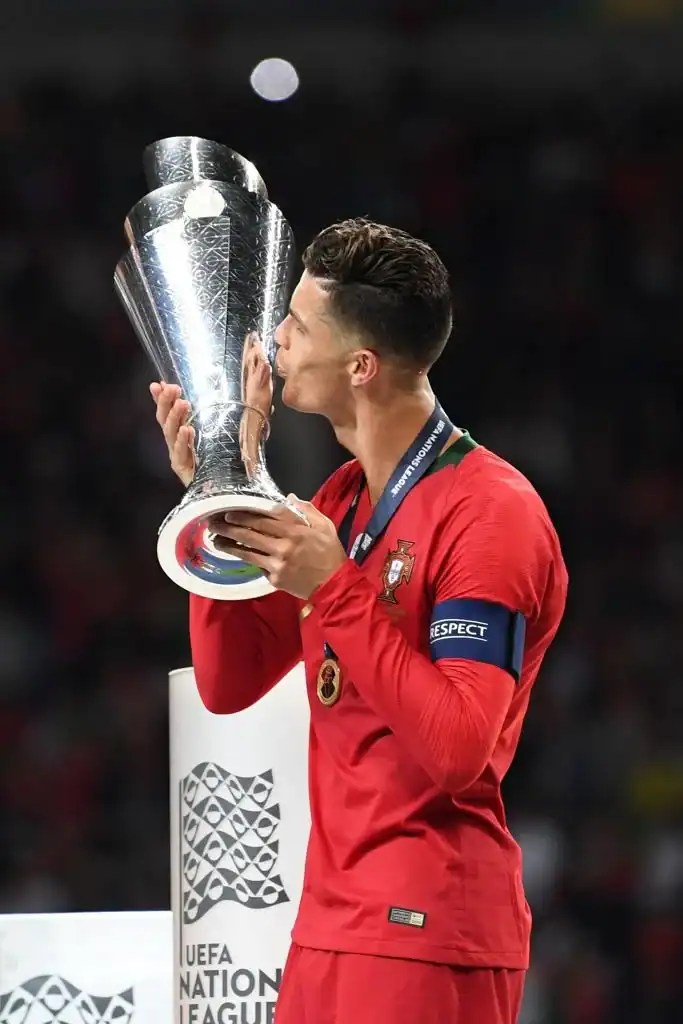 Player kissing the UEFA trophy after winning the tournament.
