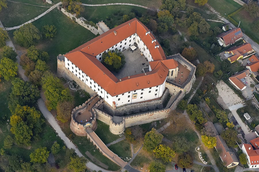 Aerial view of Buda Castle with its historic walls and red roofs in Budapest.