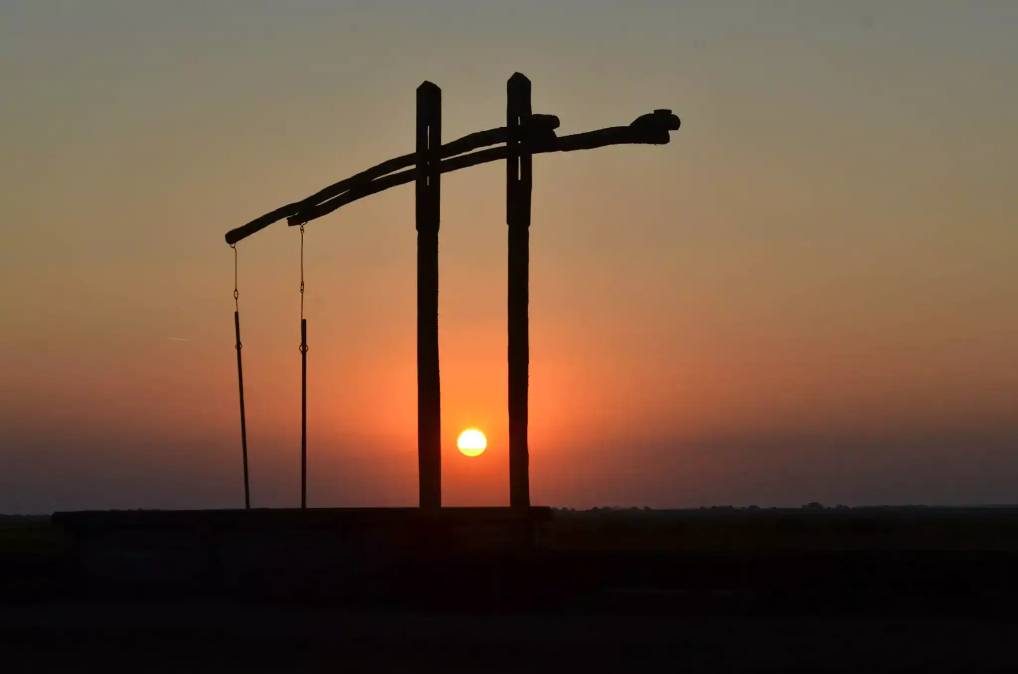 Sunset behind power lines at dusk in Hungary.