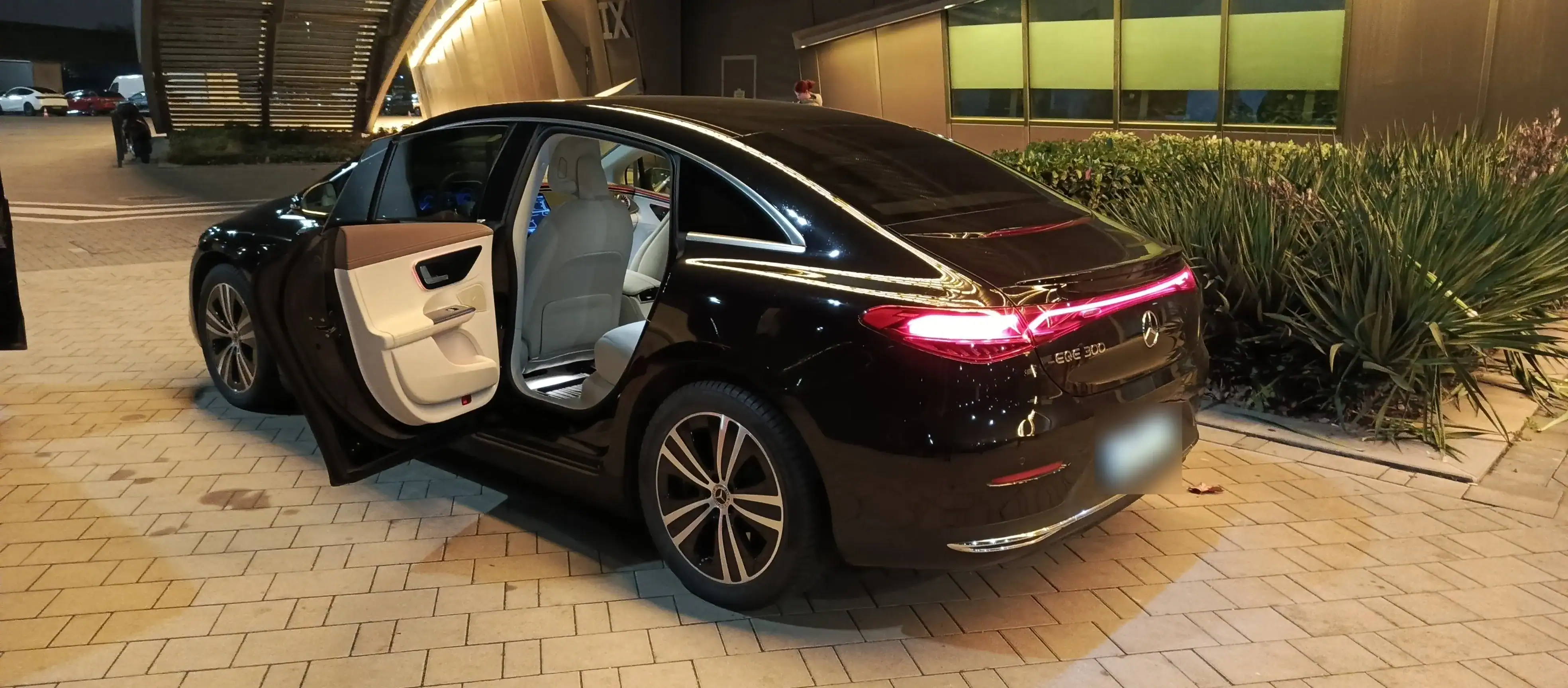 Luxury black sedan with open door, ideal for private airport and group transfers in Hungary.