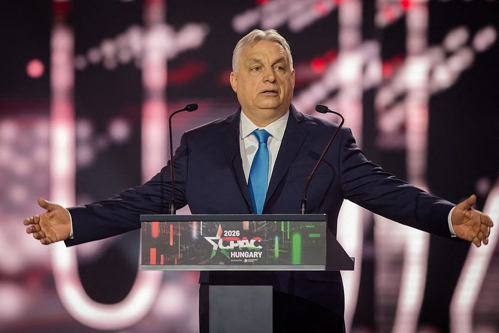 Speaker at podium with dramatic stage lighting at CPAC Hungary 2026 Budapest