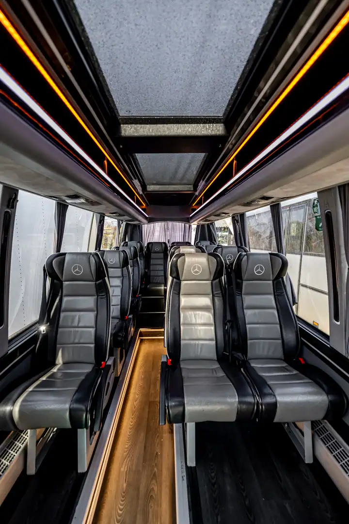 Mercedes-Benz Sprinter minibus interior with leather seats and modern lighting