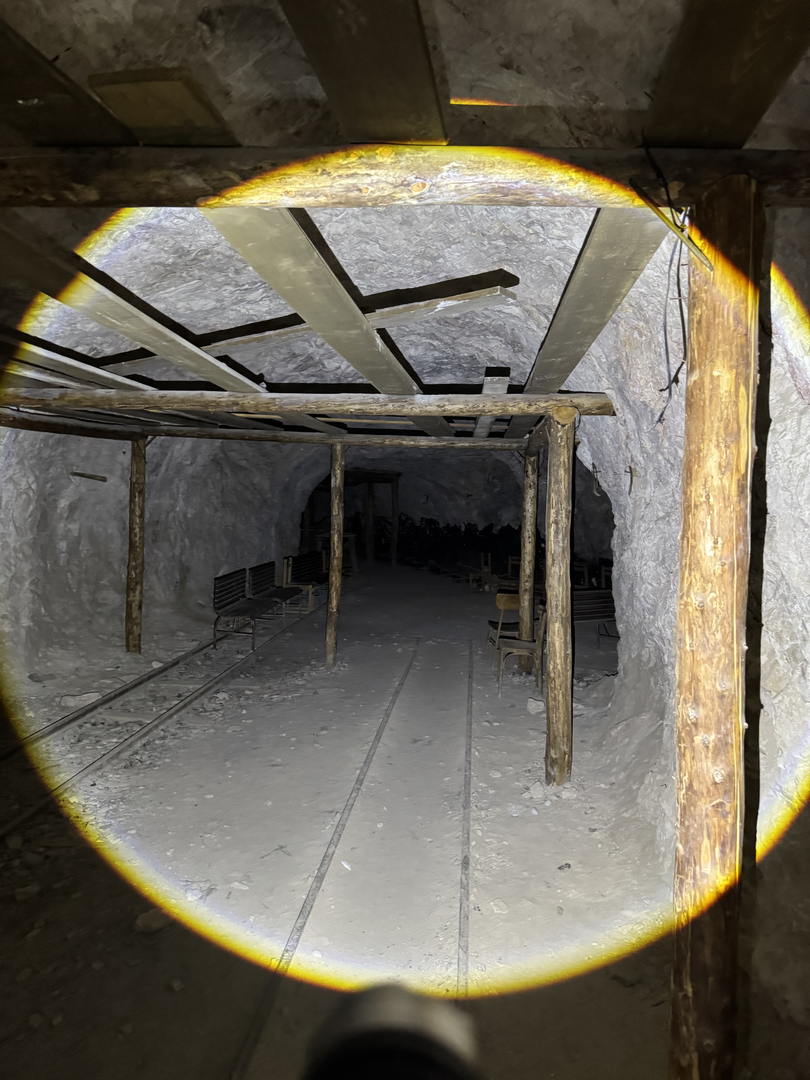 Timbered passages stretching into black