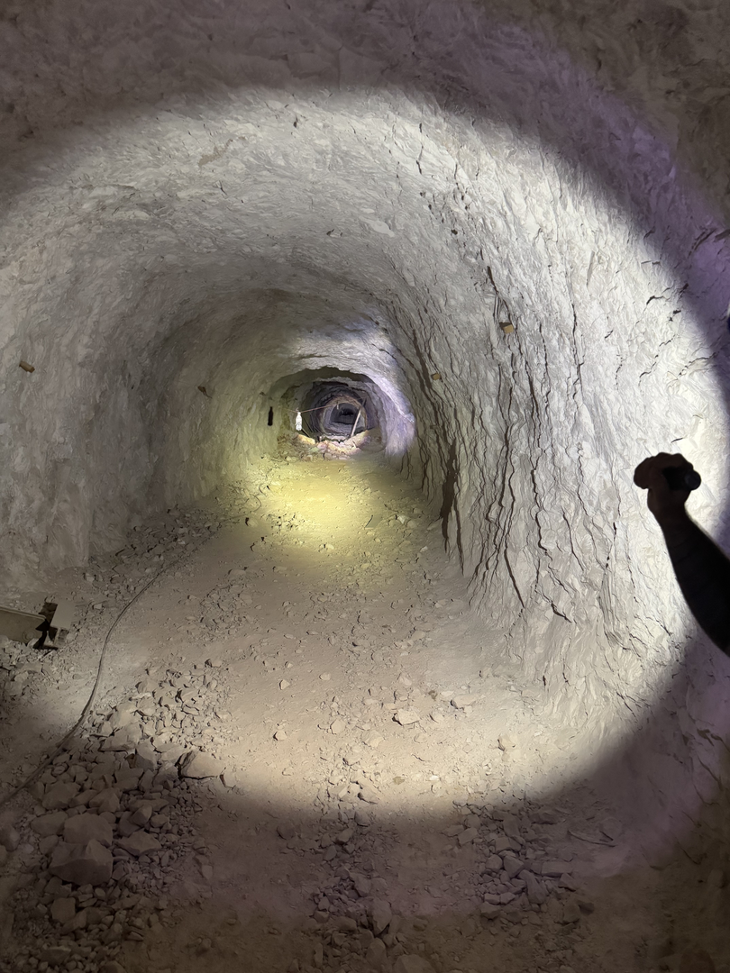 Deep into the passage, lamp ahead