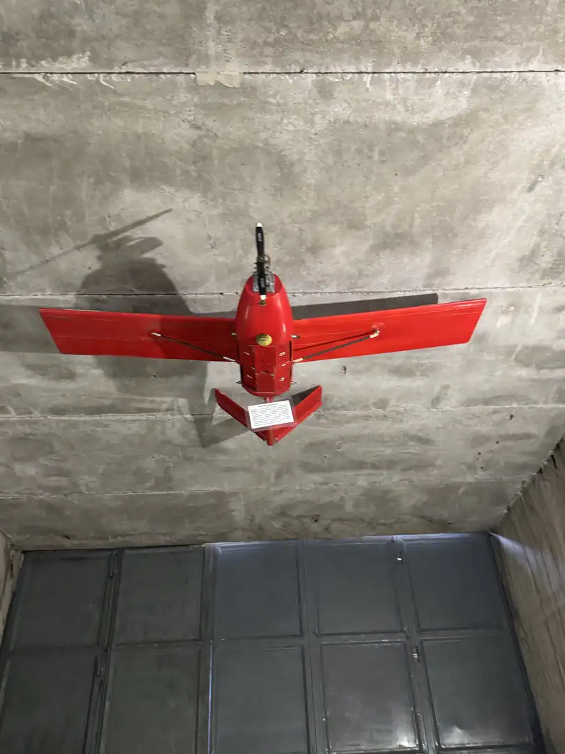 Red model aircraft mounted on the bunker wall as an exhibit