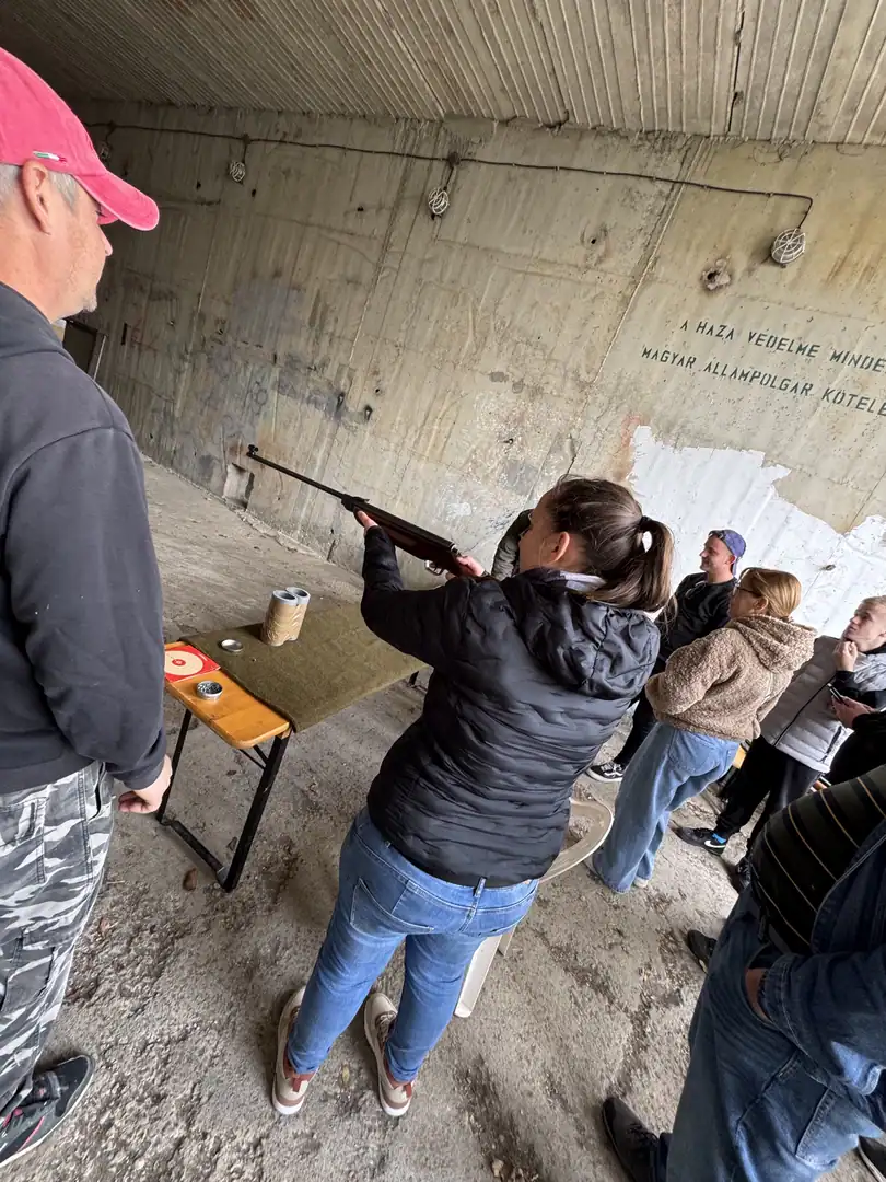 A visitor shoulders a training launcher under guidance at the event
